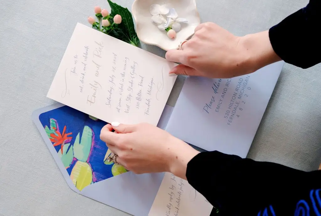 woman adjusting wedding invitations