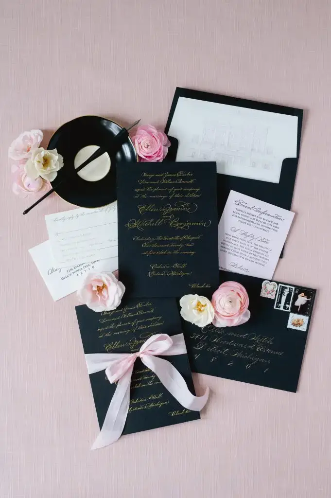 luxury wedding invitations in a black, gold, and pink motif