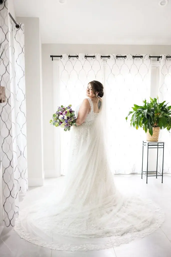 bride with purple bouquet and cathedral veil before her Mansion at Oyster Bay wedding - from Leah E. Moss Designs