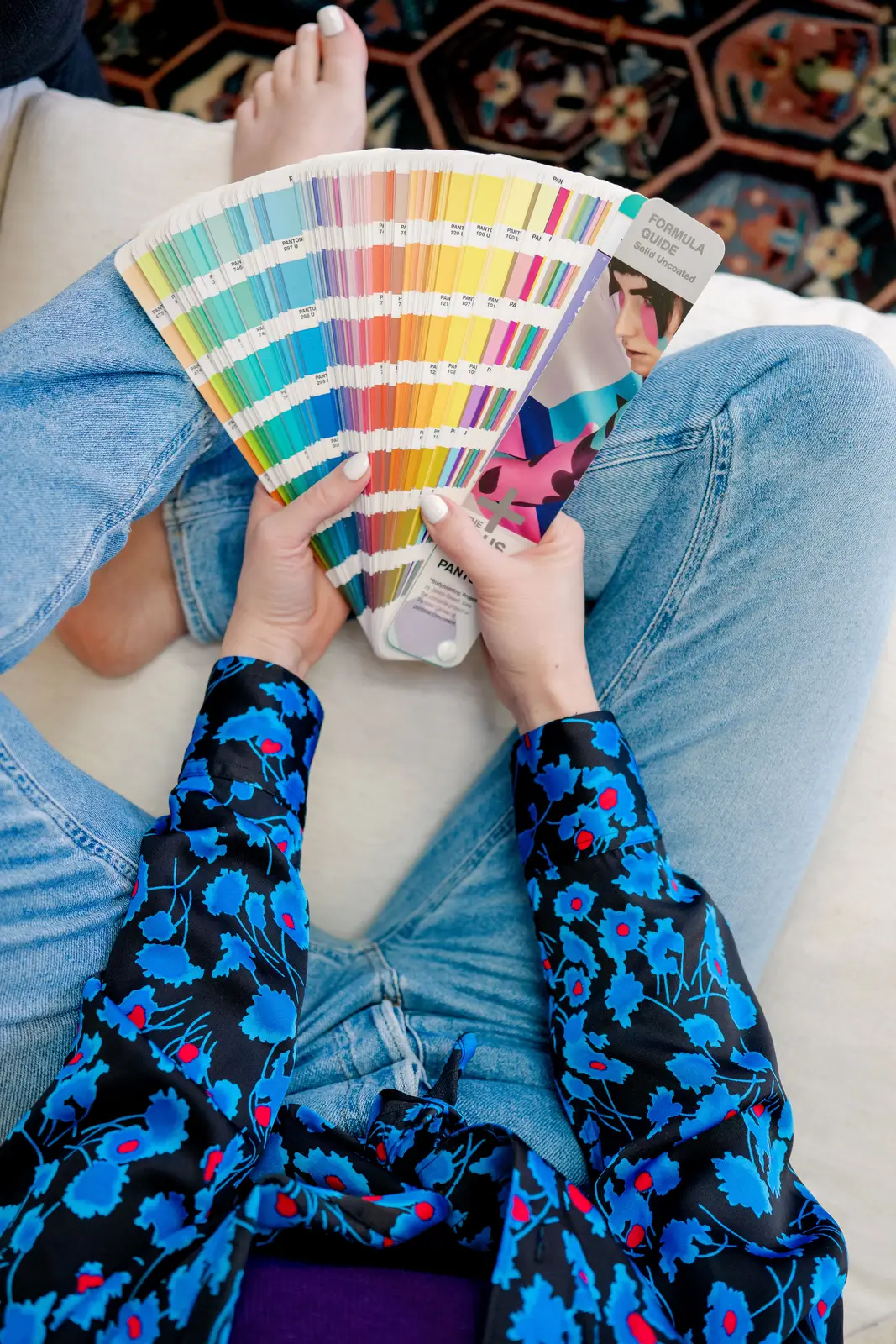 detroit wedding invitations designer holds a pantone swatch book