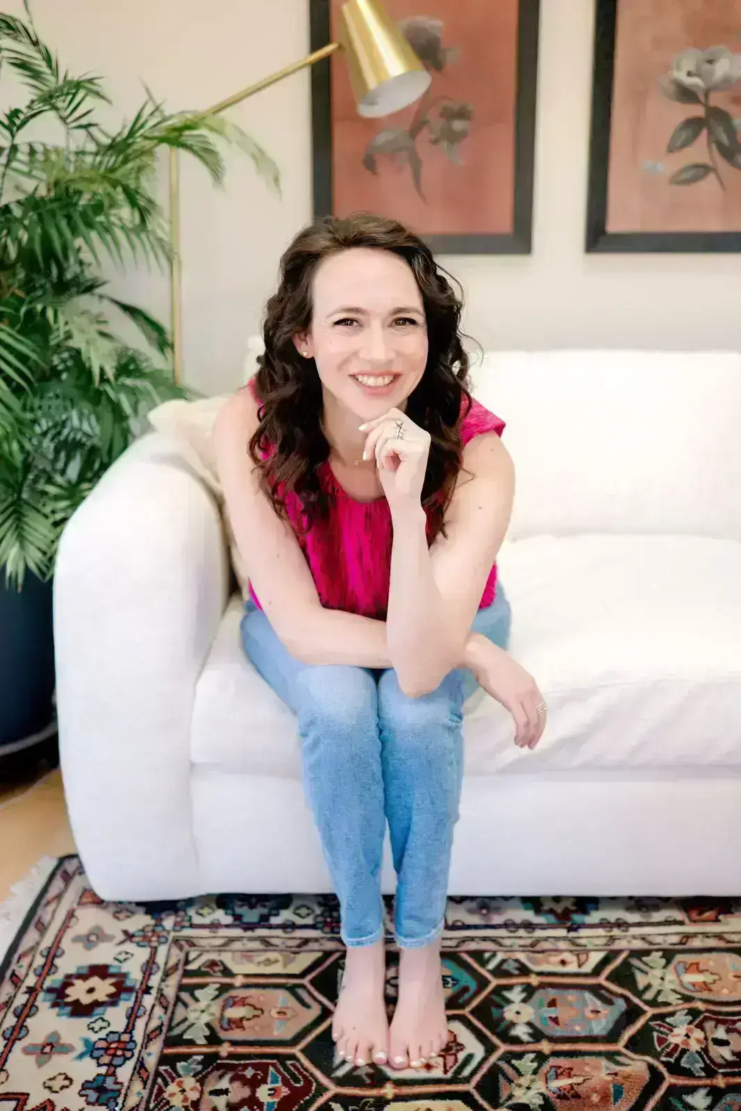 detroit wedding invitations designer leah sachs sits on a sofa