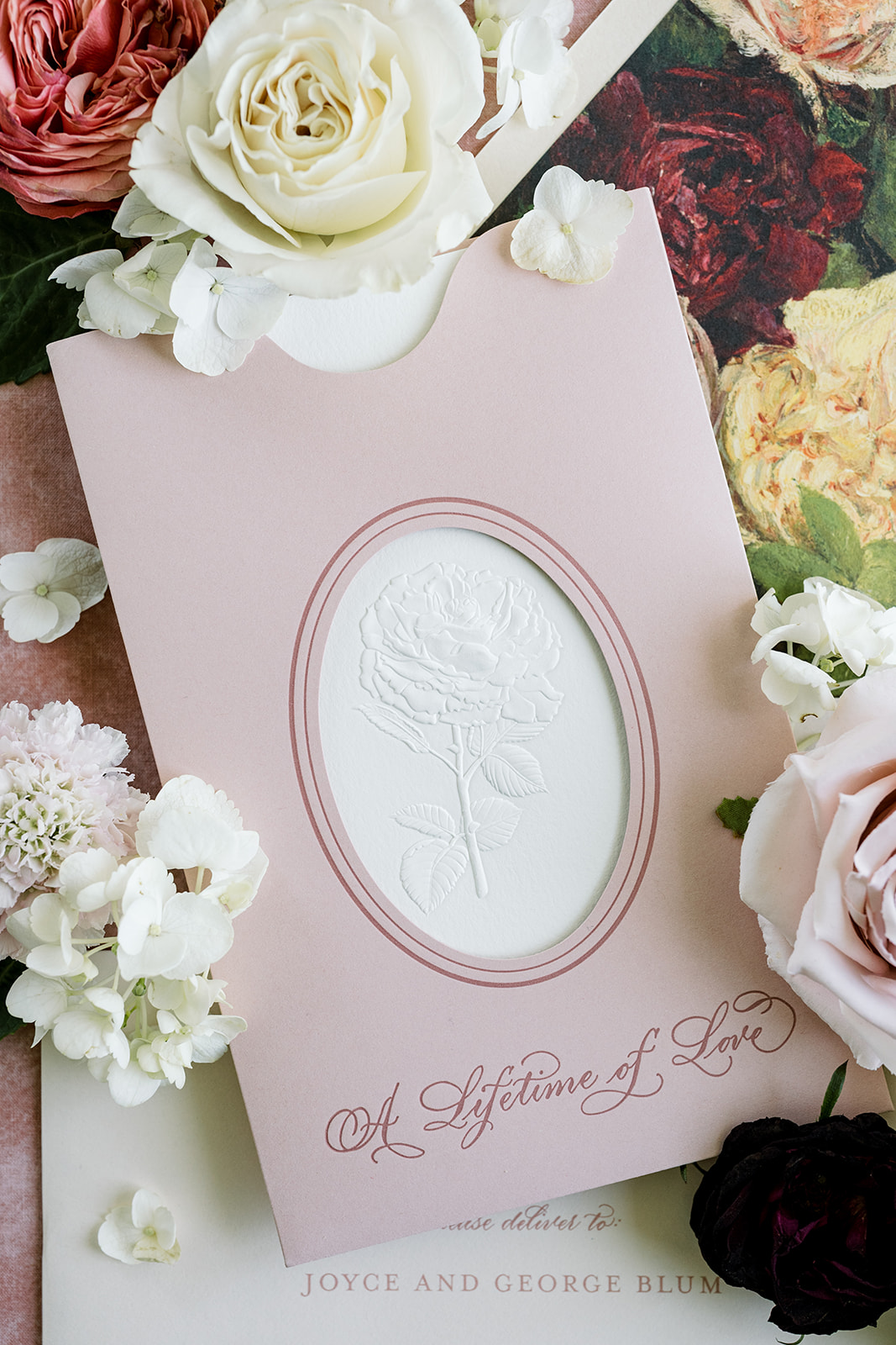 Sculpted embossing on invitation in letterpress pocket